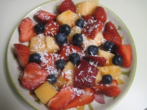 Fruits Salad with Cantaloupe, strawberries, blueberries and coconut.
