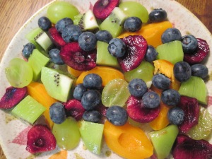 Fruit Salad with apricots, kiwi, cherries, green grapes, and blueberries.